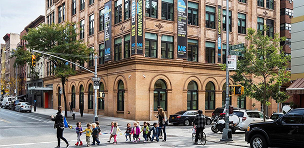 View of the Educational Alliance of New York City historic building with large, arched windows.